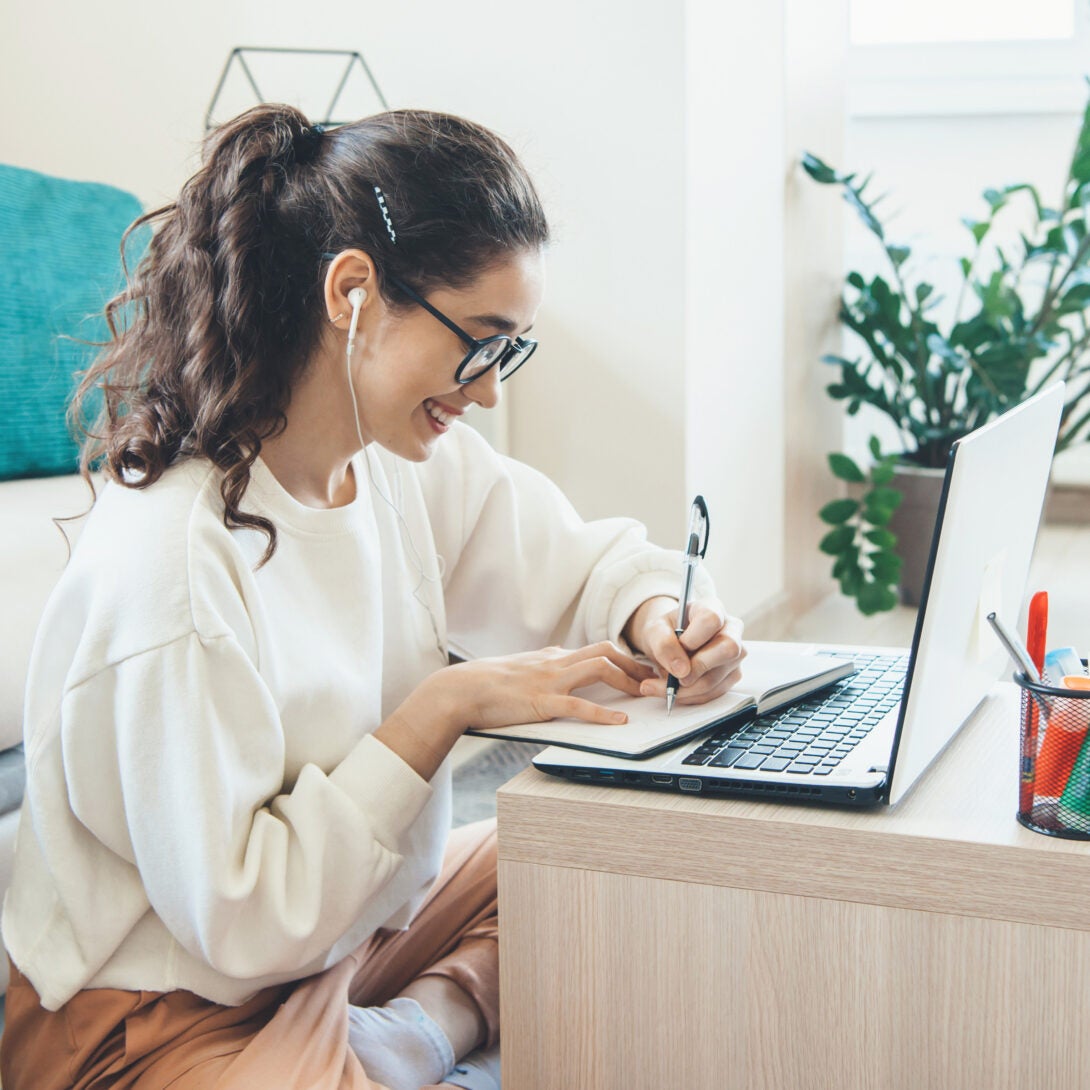 Female MESA graduate student in glasses sat at laptop taking an advanced courses